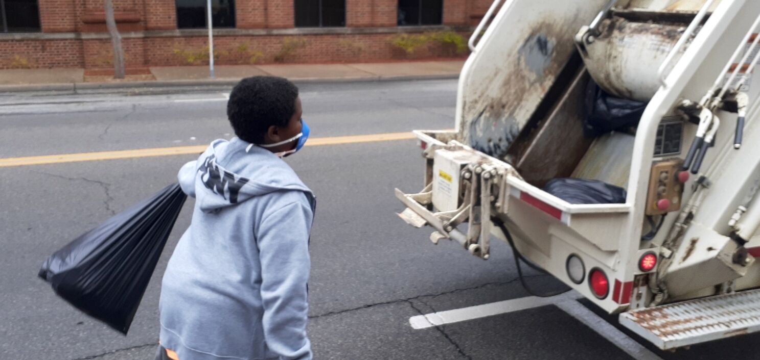 New Vision volunteers help with downtown cleanup